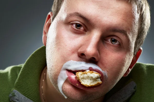 Closeup portrait of funny man. Yogurt traces on his lips — Stock Photo, Image