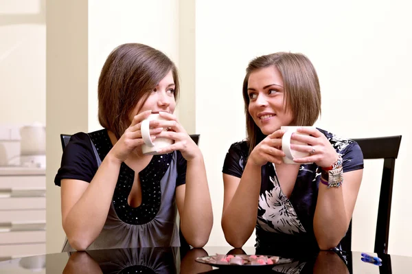 Två tjejer med koppar te — Stockfoto