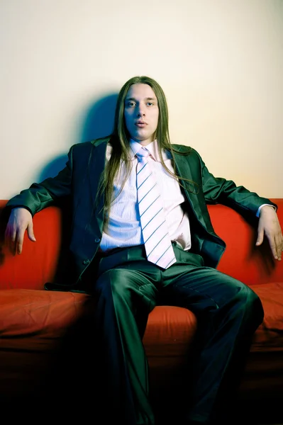 Portrait of longhaired serious man in suit Stock Picture