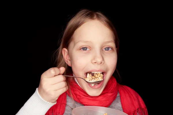 Little girl eating flakes — Stock Photo, Image