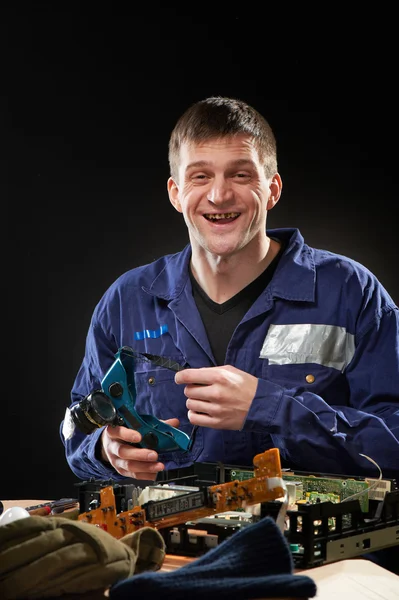 Repairing man in blue robe — Stock Photo, Image