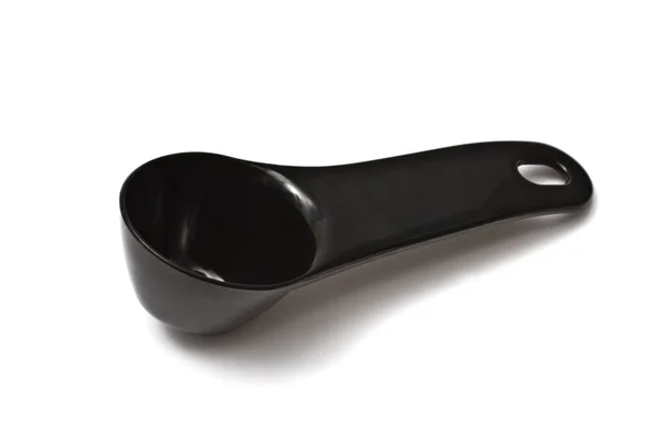 Black plastic coffee scoop — Stock Photo, Image