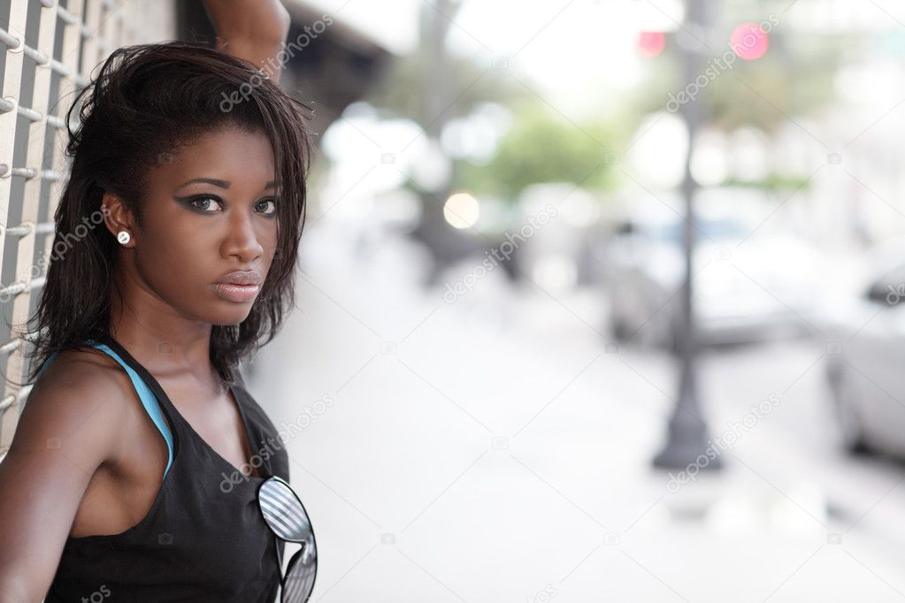 Woman posing by the sidewalk