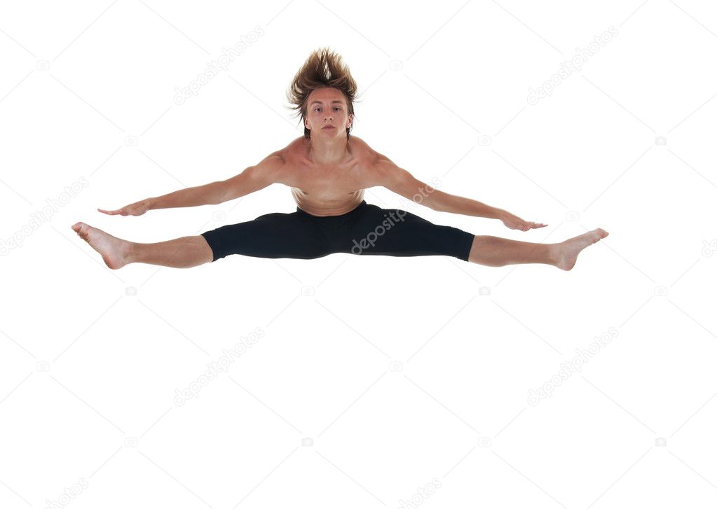 Picture of a male ballet dancer jumping with spread legs over white
