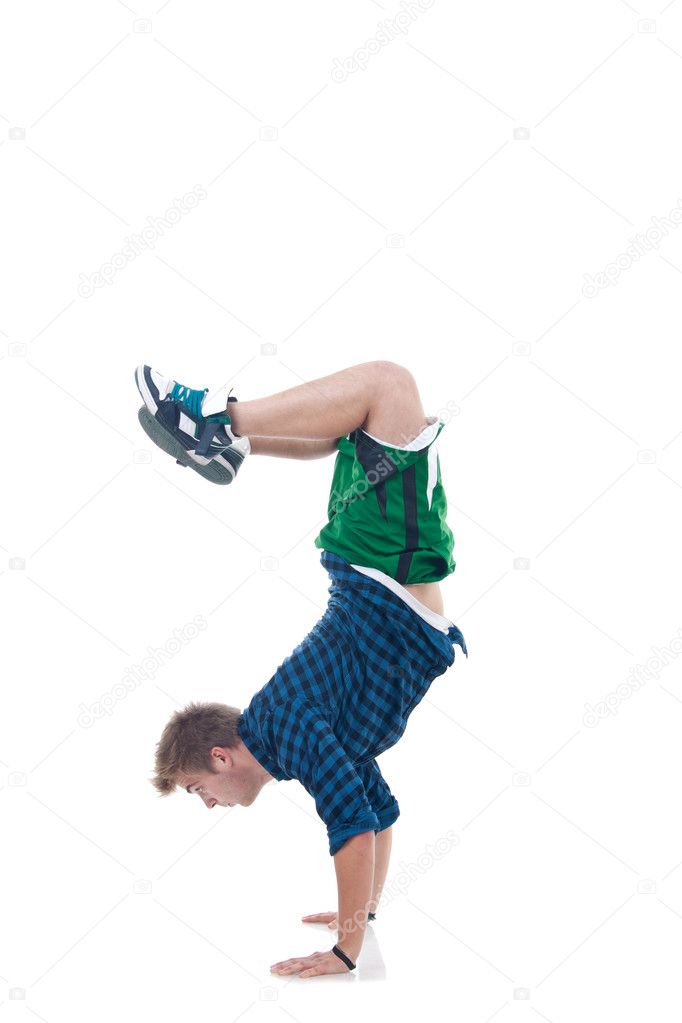Young bboy standing on hands. Holding legs in air. Isolated on white in studio. Side view, whole body