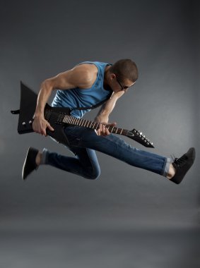 Rock star jumping with guitar clipart