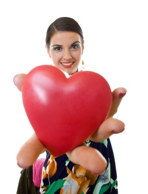 Beutiful young woman handing a big red heart over white - wide angle shot clipart