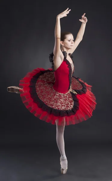 Pretty ballerina posing in a red tutu — Stock Photo, Image