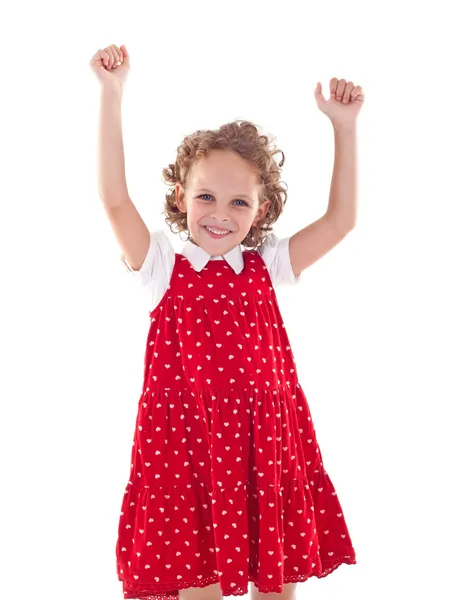 Kis lány visel egy piros ruhában, kezében a levegőben — Stock Fotó