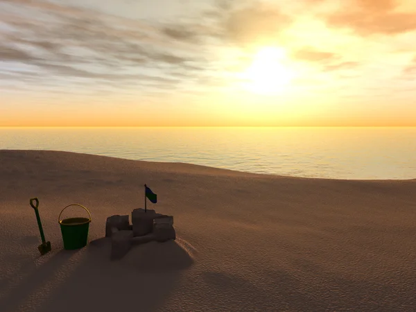 Відро, лопатка і піщаний замок на пляжі на заході сонця . — стокове фото