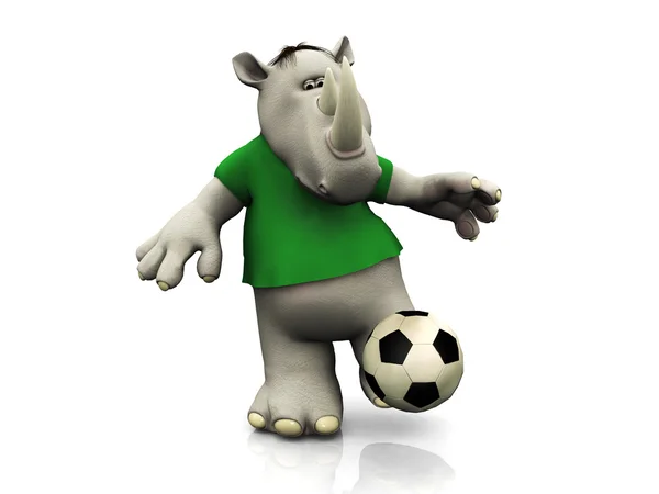 Kreslený nosorožec kopat fotbalový míč. — Stock fotografie
