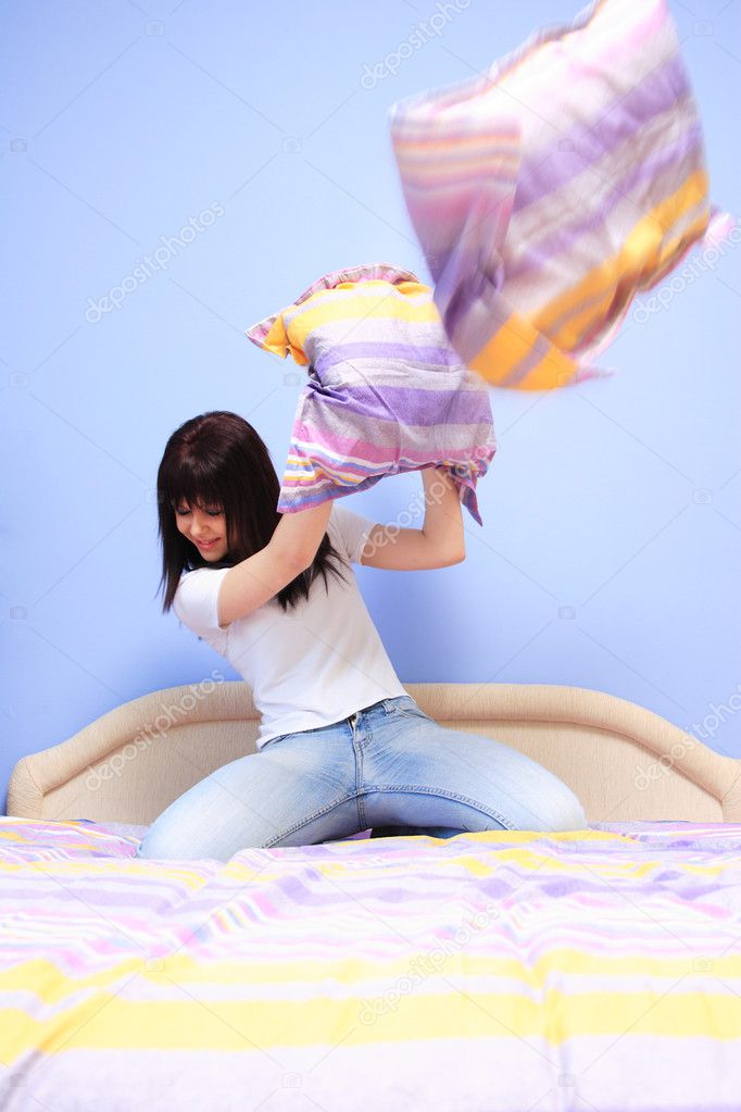 Woman having pillow fight