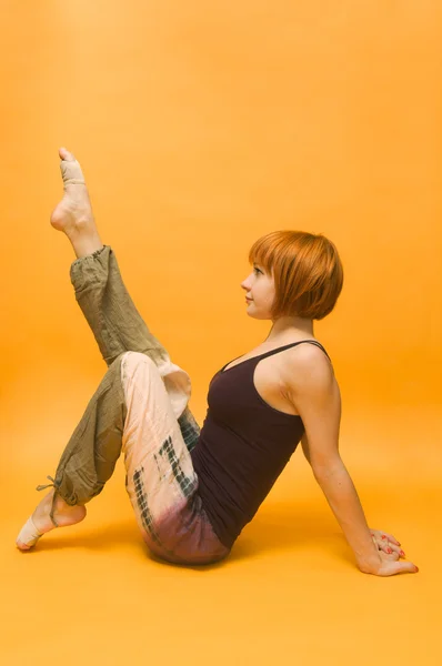 Červená holčička provádějícího jóga asana — Stock fotografie