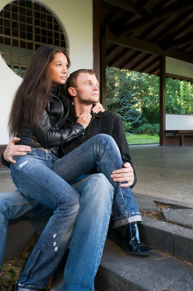 Young couple on the steps of a house — Stock Photo, Image