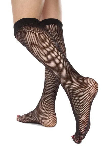 Kadın ayakları ile beyaz zemin üzerine File külotlu çorap — Stok fotoğraf