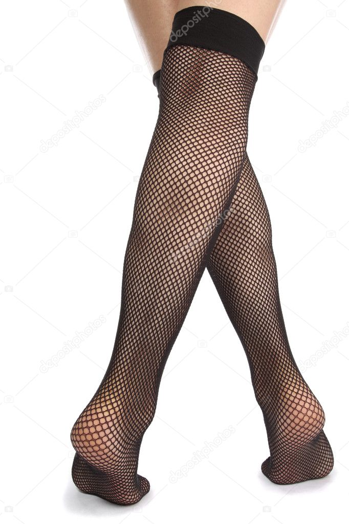 Woman feet with fishnet tights over white background