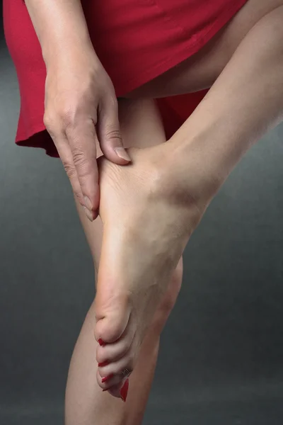 Woman massaging aching feet — Zdjęcie stockowe