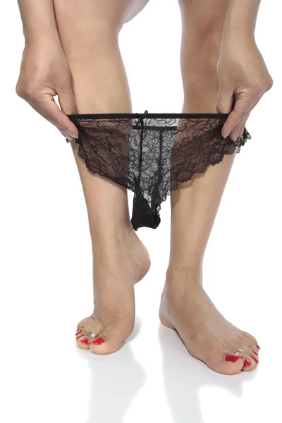 Sexy nogi z czarną bieliznę rozbieranie na białe tło — Zdjęcie stockowe