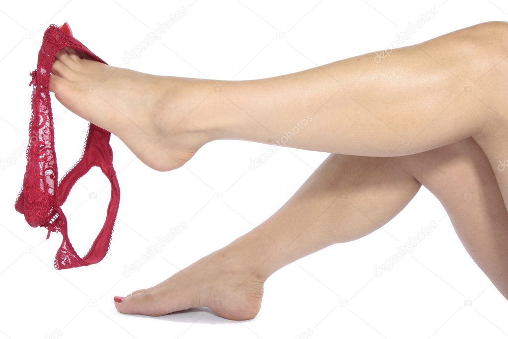Sexy legs with red underwear undressing over white background