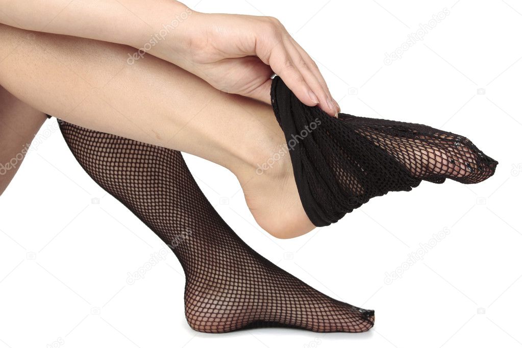Woman feet putting on stockings