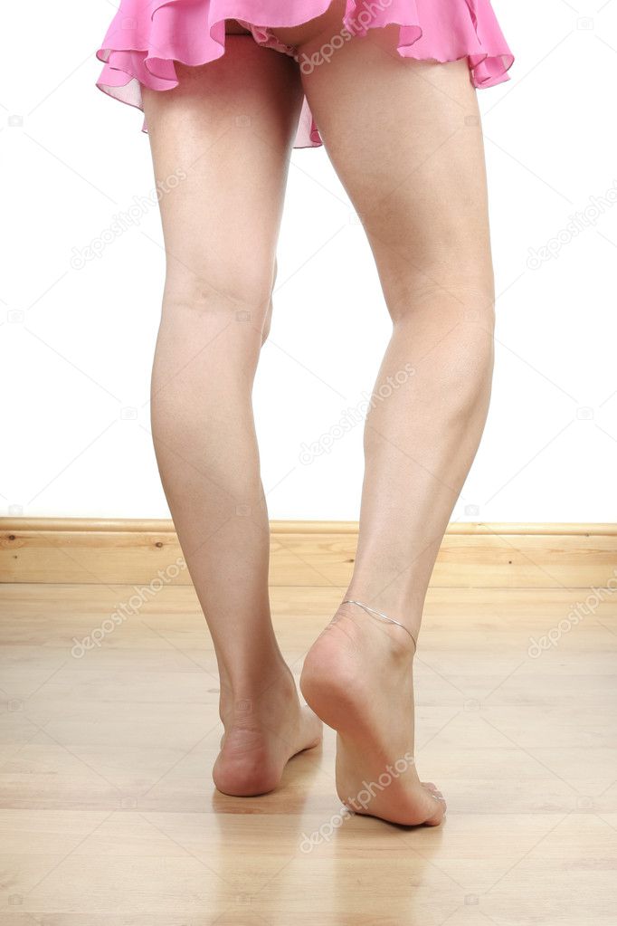 Woman legs with pink nightie isolated over white