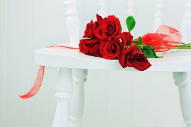 Red Roses on a White Chair clipart