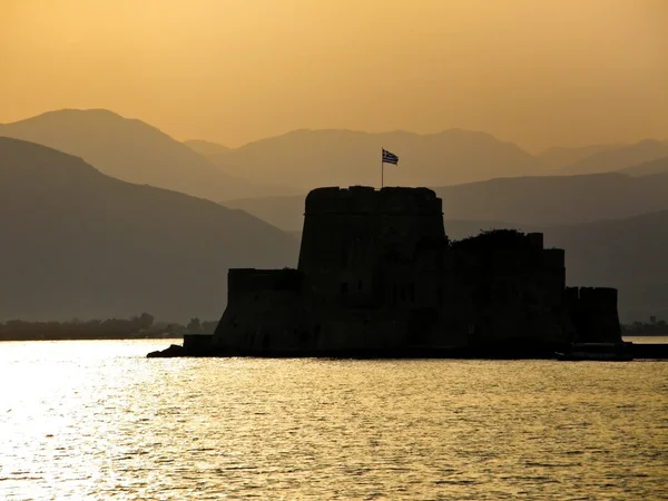 Fortress in ocean at sunset