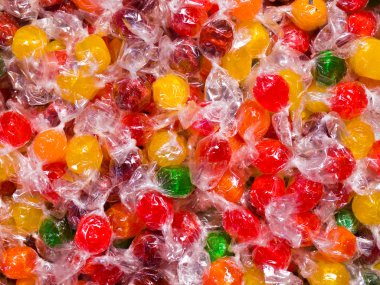 Colorful Hard Candy in Wrappers as a Background clipart