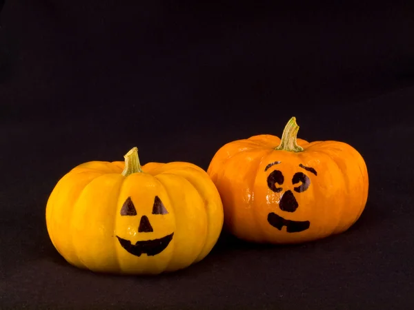 Mini Pumpkins with Funny Faces with a Black Cloth Background — Stock Photo, Image
