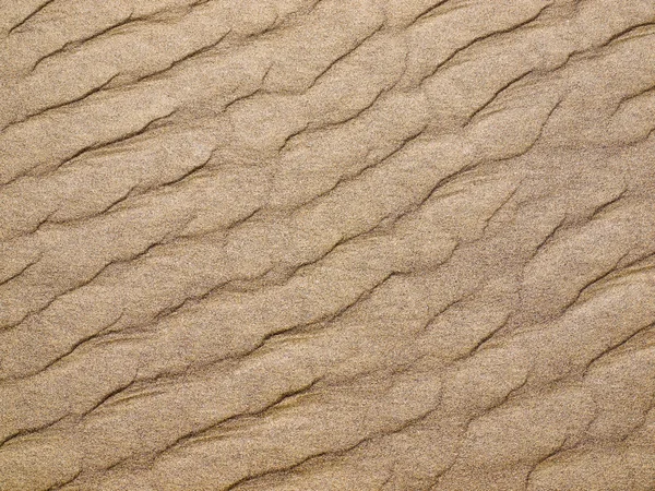 Fond abstrait des ondulations de sable à la plage — Photo