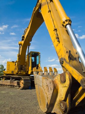 Heavy Duty Construction Equipment Parked at Worksite clipart