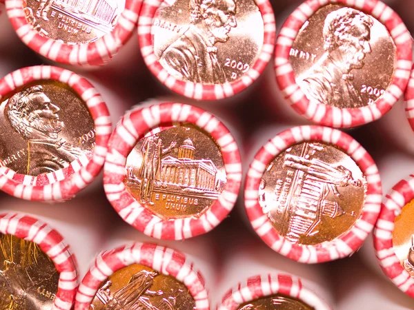 Penny Rolls Lined Up in a Box of Coins
