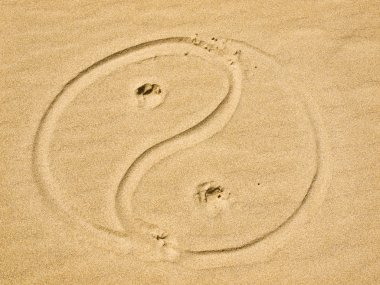 Yin and Yang Symbol Written in the Sand on a Sunny Day clipart