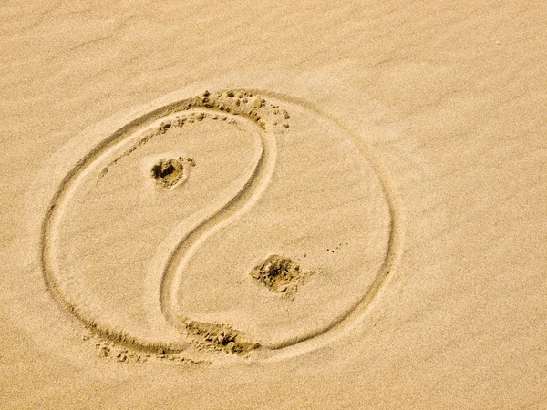 stock image Yin and Yang Symbol Written in the Sand on a Sunny Day