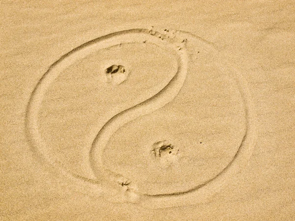 stock image Yin and Yang Symbol Written in the Sand on a Sunny Day