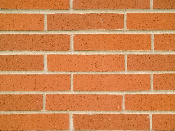 Orange, röd och brun tegel vägg bakgrund — Stockfoto