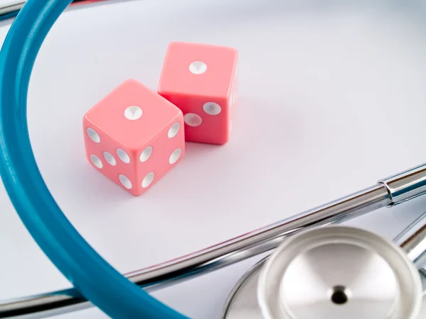 Pink Dice and a Stethoscope — Stock Photo, Image