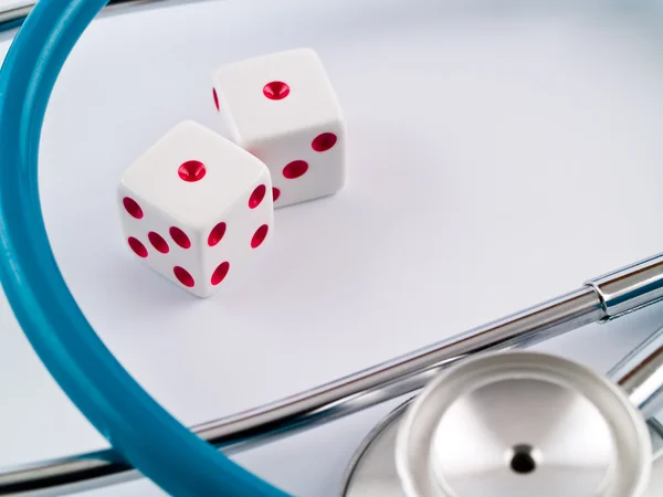 stock image White Dice with Red Dots and a Stethoscope