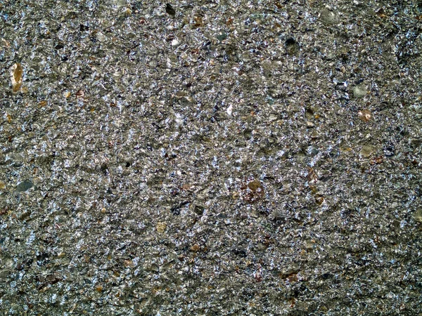 Shiny concrete wall of small rocks — Stock Photo, Image