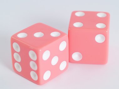 Two pink dice closeup on a white background clipart