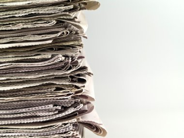 Old newspapers stacked from the top to bottom of the frame isolated on whit clipart