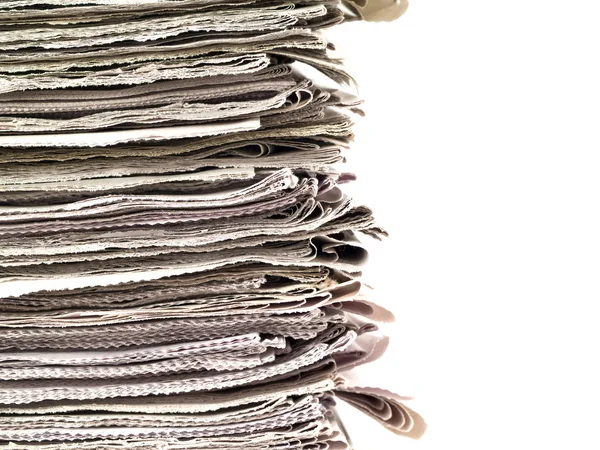 Old newspapers stacked from the top to bottom of the frame isolated on whit — Stock Photo, Image