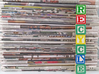 A Pile of Newspapers with the Word RECYCLE in Alpahbet Blacks clipart