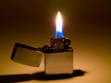 A cigarette lighter with a yellow and blue flame clipart