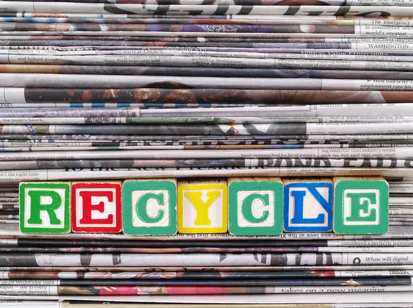 stock image A Pile of Newspapers with the Word RECYCLE in Alpahbet Blacks