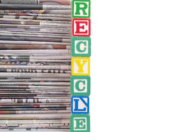 A Pile of Newspapers with the Word RECYCLE in Alpahbet Black — стоковое фото