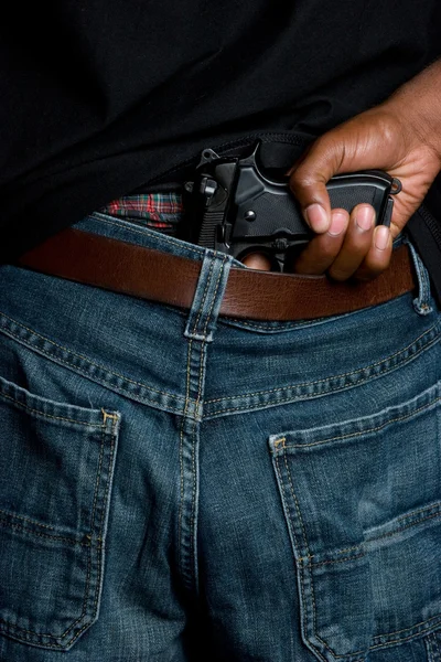 Pistola em calças — Fotografia de Stock