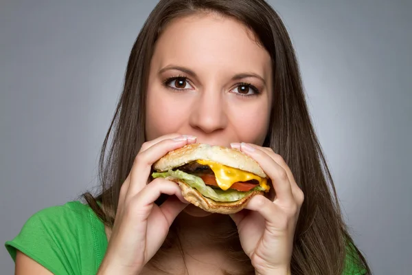 Woman Eating Hamburger — Stock Photo © keeweeboy #3872370