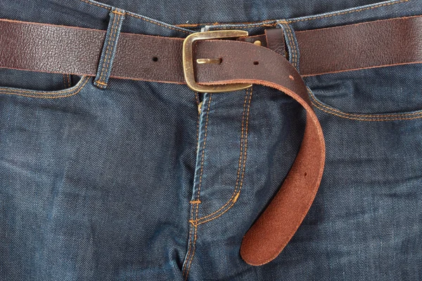 stock image Blue jeans with old brown belt