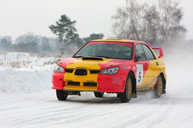 Red and yellow rally car on snow clipart
